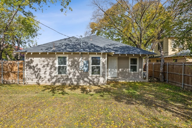 rear view of house with a yard