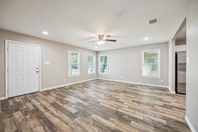 unfurnished room featuring hardwood / wood-style floors, plenty of natural light, and ceiling fan