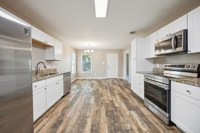 kitchen featuring sink, white cabinets, and stainless steel appliances