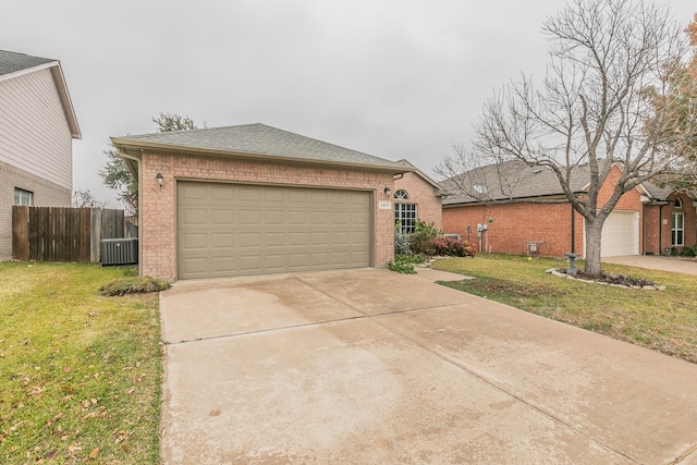 ranch-style house with cooling unit, a front yard, and a garage