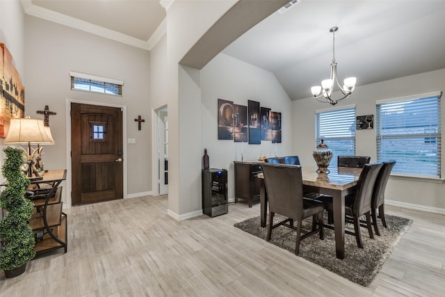 dining area with wine cooler, crown molding, and a notable chandelier