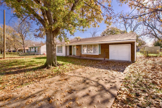 single story home with a front lawn and a garage