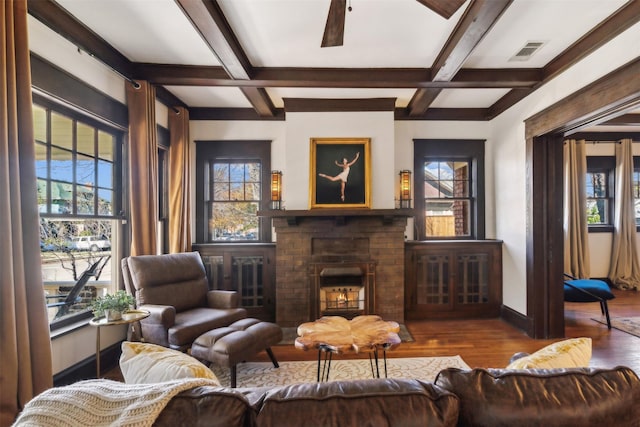 living room featuring beam ceiling, ceiling fan, coffered ceiling, and hardwood / wood-style flooring