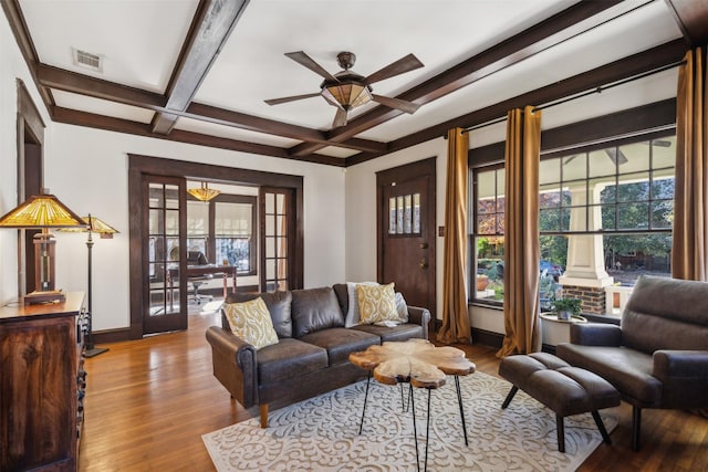 living room with french doors, coffered ceiling, a wealth of natural light, and beamed ceiling