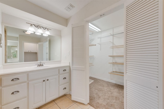 bathroom with tile patterned flooring and vanity