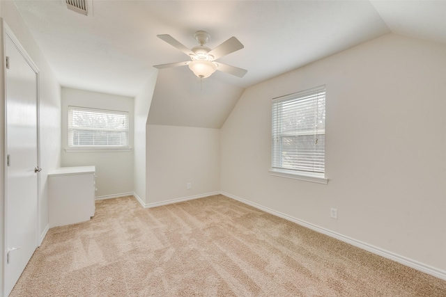 bonus room featuring ceiling fan, lofted ceiling, light carpet, and a wealth of natural light