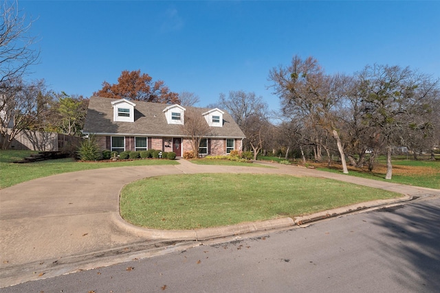 new england style home featuring a front lawn