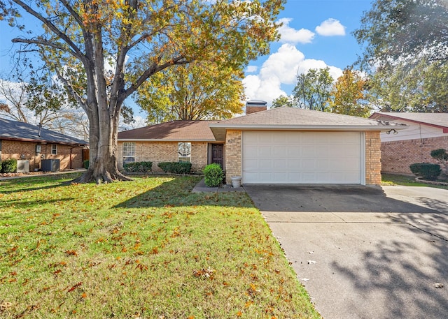 view of front of house with a front yard, a garage, and cooling unit