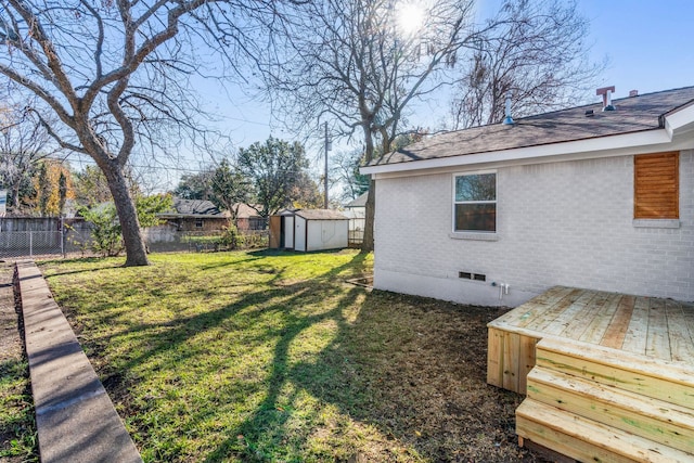 view of yard featuring a storage unit and a deck