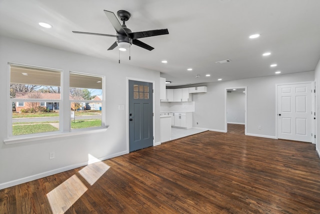 unfurnished living room with ceiling fan, a wall mounted AC, and dark hardwood / wood-style flooring