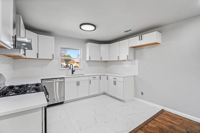 kitchen featuring decorative backsplash, stainless steel appliances, ventilation hood, sink, and white cabinets