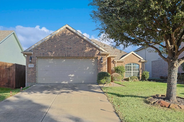 view of front of property with a garage and a front lawn