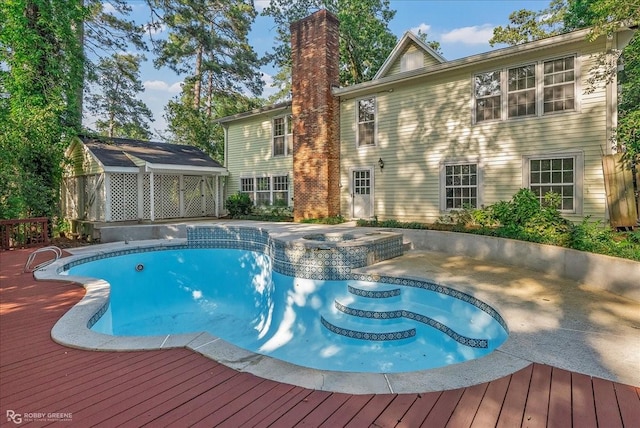 view of pool with an in ground hot tub