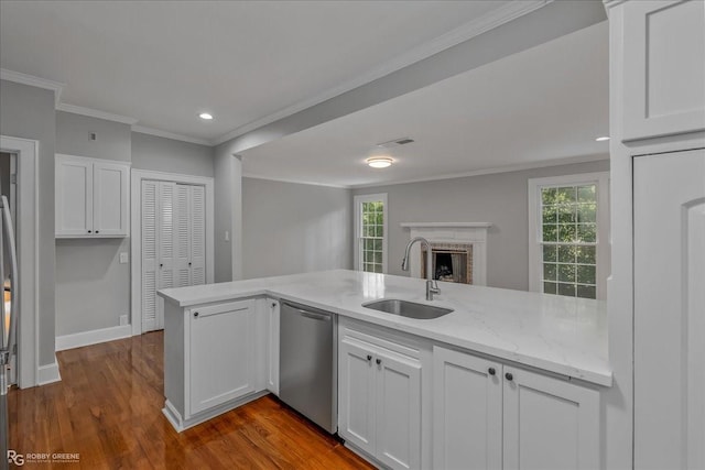 kitchen with white cabinets, dishwasher, kitchen peninsula, and sink