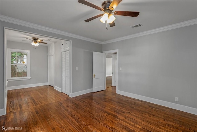 unfurnished room with ceiling fan, dark hardwood / wood-style flooring, and ornamental molding