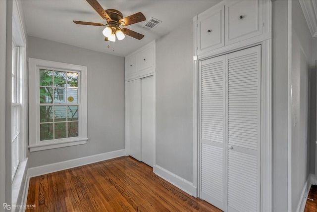 unfurnished bedroom featuring wood-type flooring, a closet, and ceiling fan