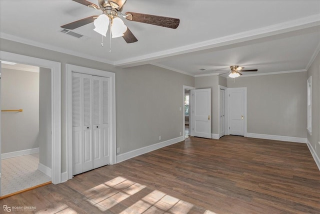 unfurnished bedroom featuring ceiling fan, dark hardwood / wood-style flooring, and ornamental molding