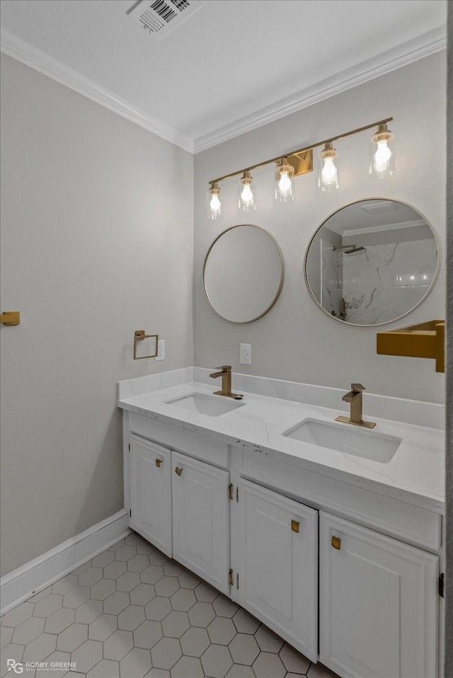 bathroom featuring tile patterned floors, crown molding, and vanity