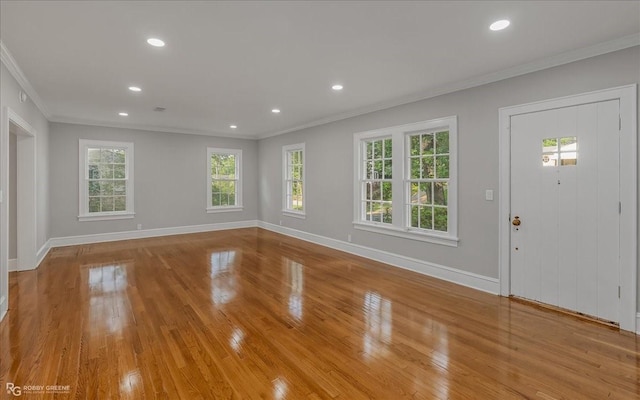 entrance foyer with crown molding and light hardwood / wood-style floors