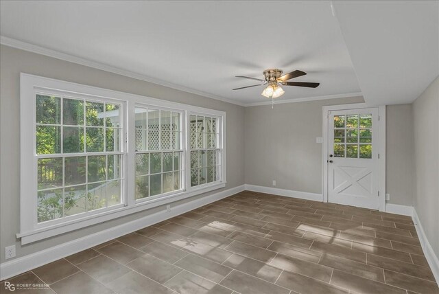 empty room with ceiling fan and crown molding