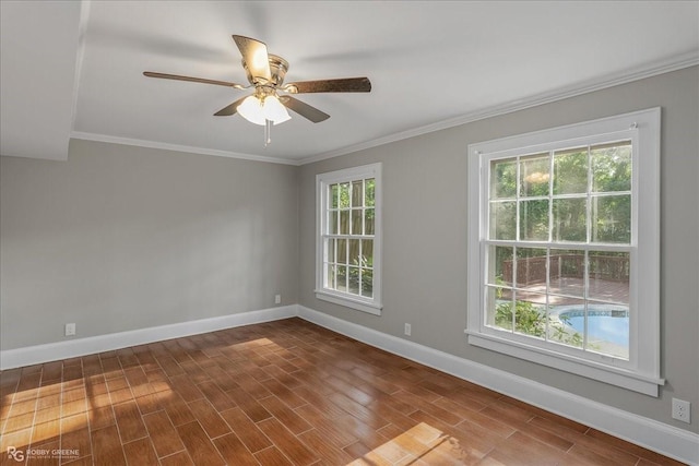 spare room featuring wood-type flooring, ornamental molding, and a wealth of natural light