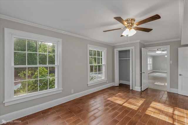 unfurnished bedroom with hardwood / wood-style floors, ceiling fan, crown molding, and multiple windows