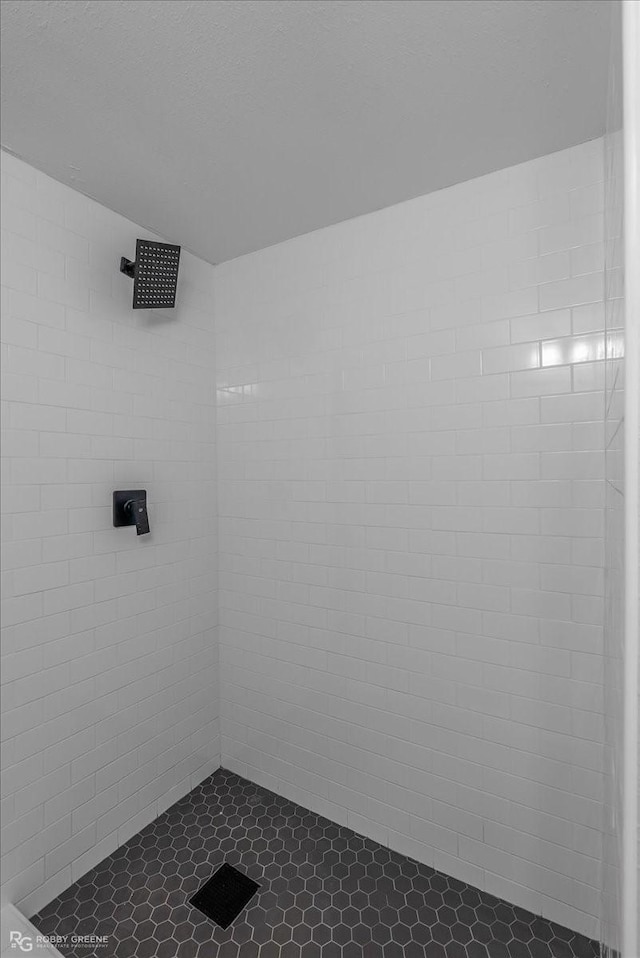 bathroom with tiled shower