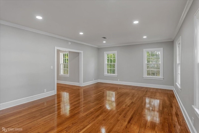 empty room featuring hardwood / wood-style flooring and ornamental molding