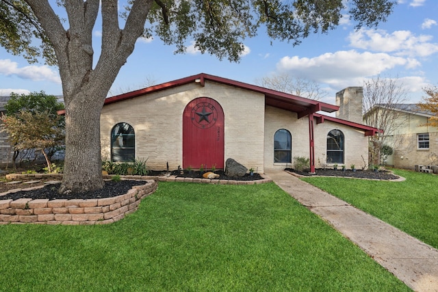 mediterranean / spanish home with a front lawn