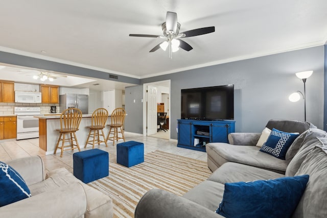 tiled living room with ceiling fan and ornamental molding