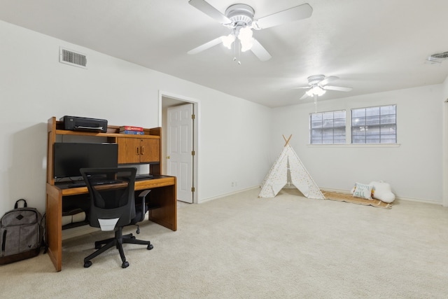 home office with ceiling fan and light carpet