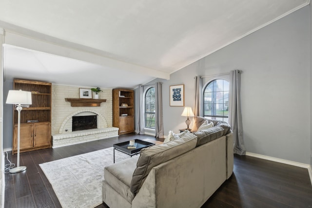 living room featuring vaulted ceiling with beams, dark hardwood / wood-style flooring, a fireplace, and ornamental molding