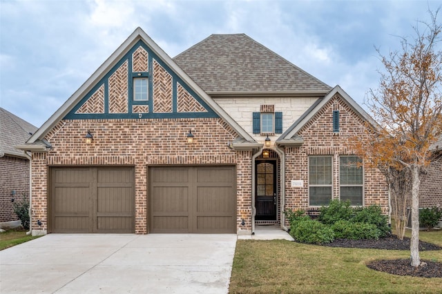 view of front of property featuring a front yard and a garage