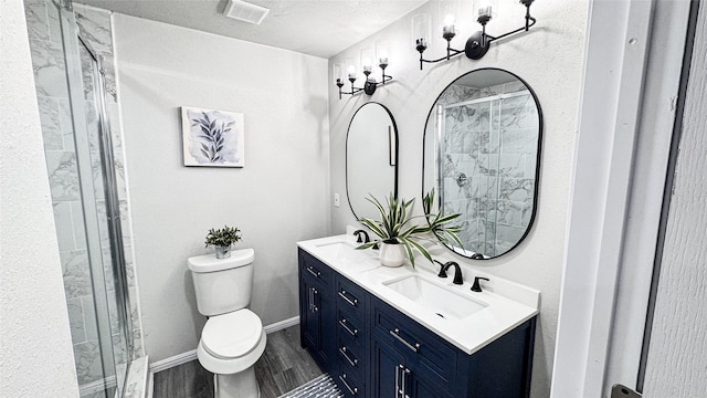 bathroom with vanity, wood-type flooring, toilet, and walk in shower