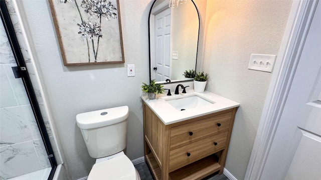 bathroom with vanity, toilet, and an enclosed shower