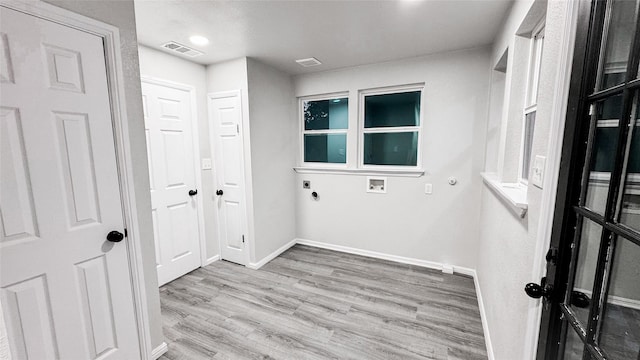 washroom featuring electric dryer hookup, washer hookup, and light hardwood / wood-style floors