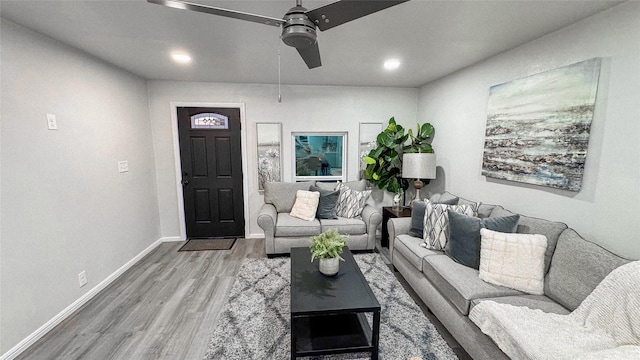 living room featuring ceiling fan and hardwood / wood-style floors