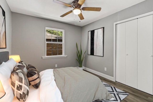 bedroom with ceiling fan, dark hardwood / wood-style flooring, and a closet