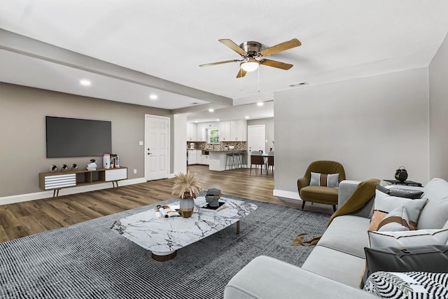 living room featuring ceiling fan and wood-type flooring