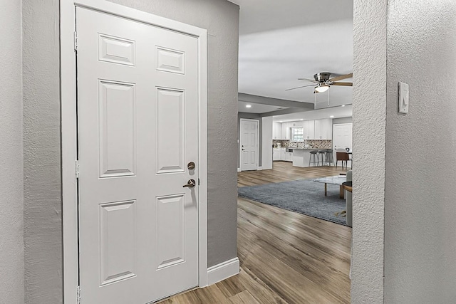 hallway with light hardwood / wood-style floors