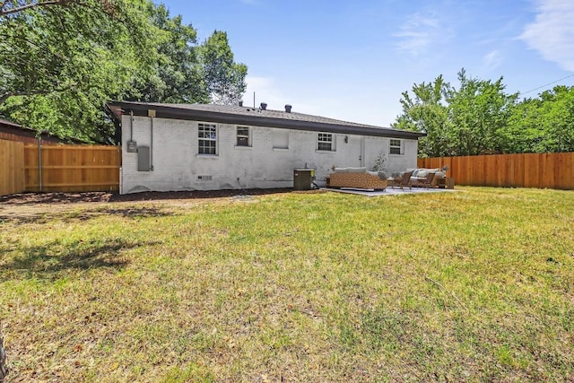 back of house with a lawn, central air condition unit, and an outdoor living space