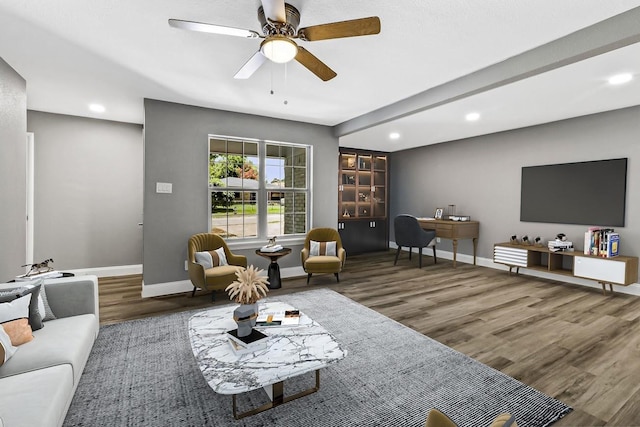 living room with wood-type flooring and ceiling fan