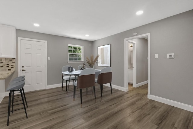 dining space with dark hardwood / wood-style flooring