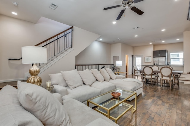 living room with dark hardwood / wood-style flooring and ceiling fan