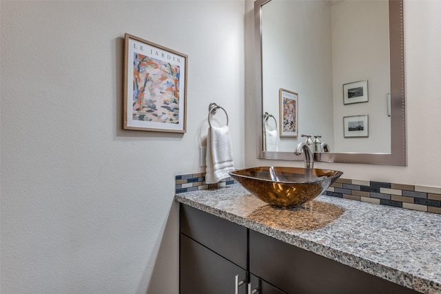 bathroom with decorative backsplash and vanity