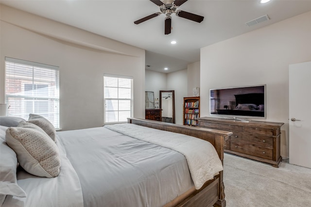 carpeted bedroom featuring multiple windows and ceiling fan