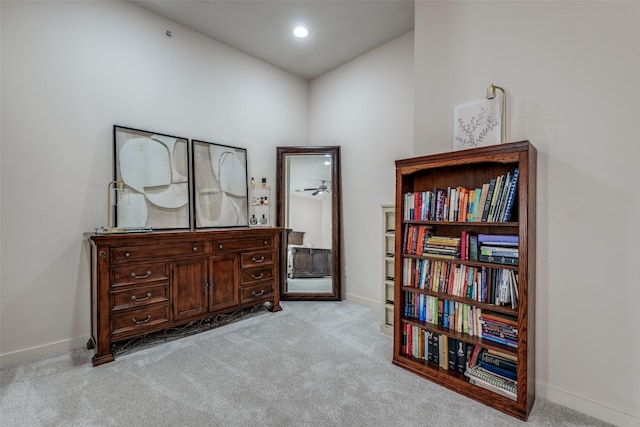 living area featuring light carpet