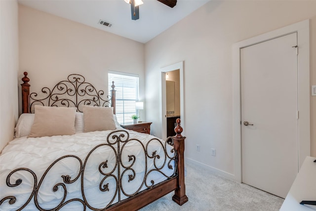 carpeted bedroom featuring connected bathroom and ceiling fan