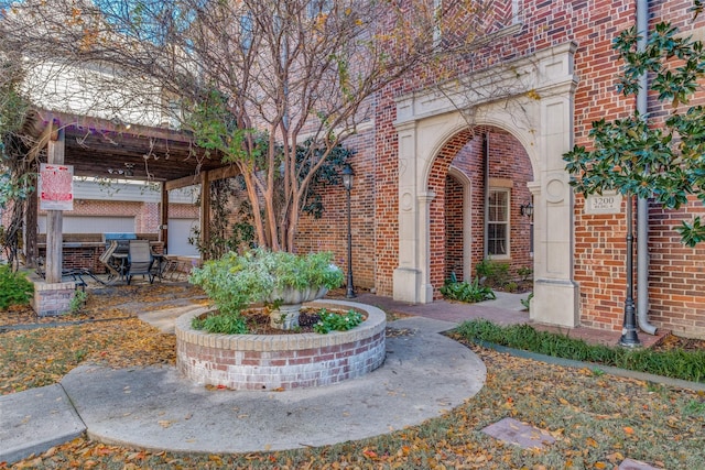 view of exterior entry featuring a patio area