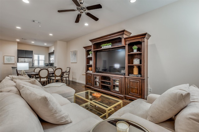 living room featuring hardwood / wood-style floors and ceiling fan